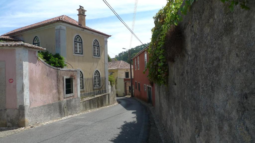 an alley in a town with buildings and a street at ribeira dos marinheiros amarelo in Sintra