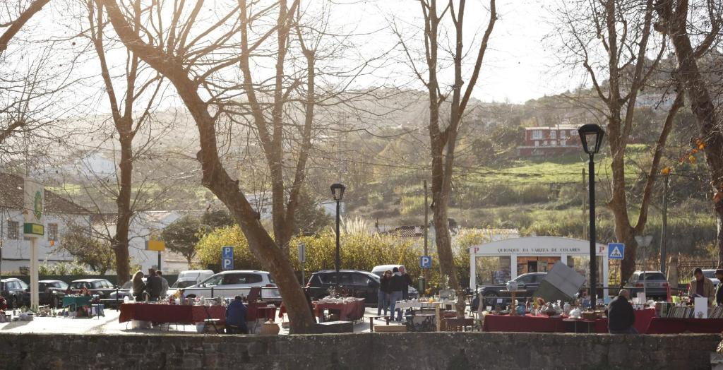 a parking lot with tables and cars in a park at ribeira dos marinheiros amarelo in Sintra