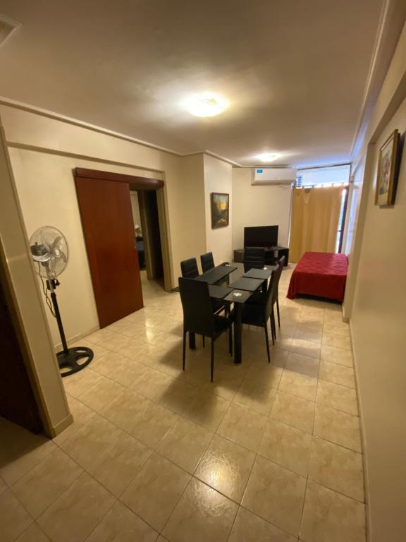 a room with a table and chairs and a living room at Junin Centro Apartament in San Miguel de Tucumán