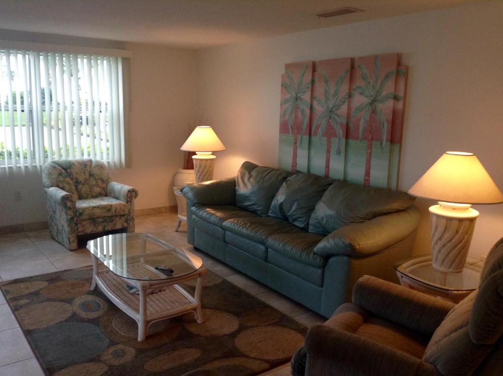 a living room with a couch and a coffee table at Island House Beach Resort 21 in Point O'Rocks