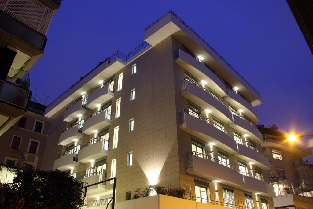 a white building with lights on it at night at Residence Hotel Parioli in Rome