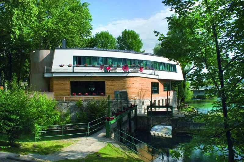 a house with a river in front of it at Hotel Paviljon in Bihać