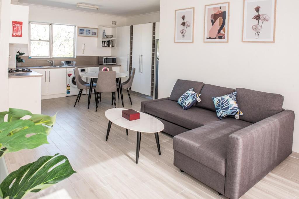 a living room with a couch and a table at Lotus Stay Manly - Apartment 29G in Sydney