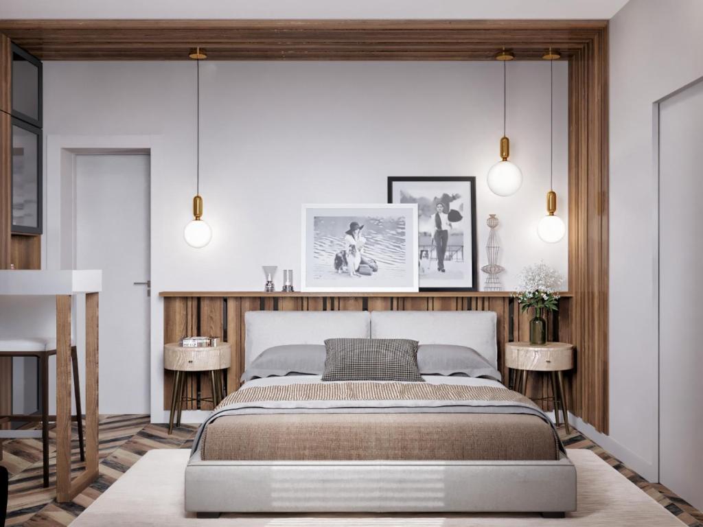 een slaapkamer met een bed en 2 tafels bij Art’partment in Braşov
