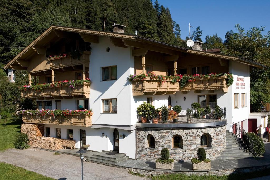ein Gebäude mit Blumenkästen auf den Balkonen in der Unterkunft Gästehaus Rauch in Schwendau