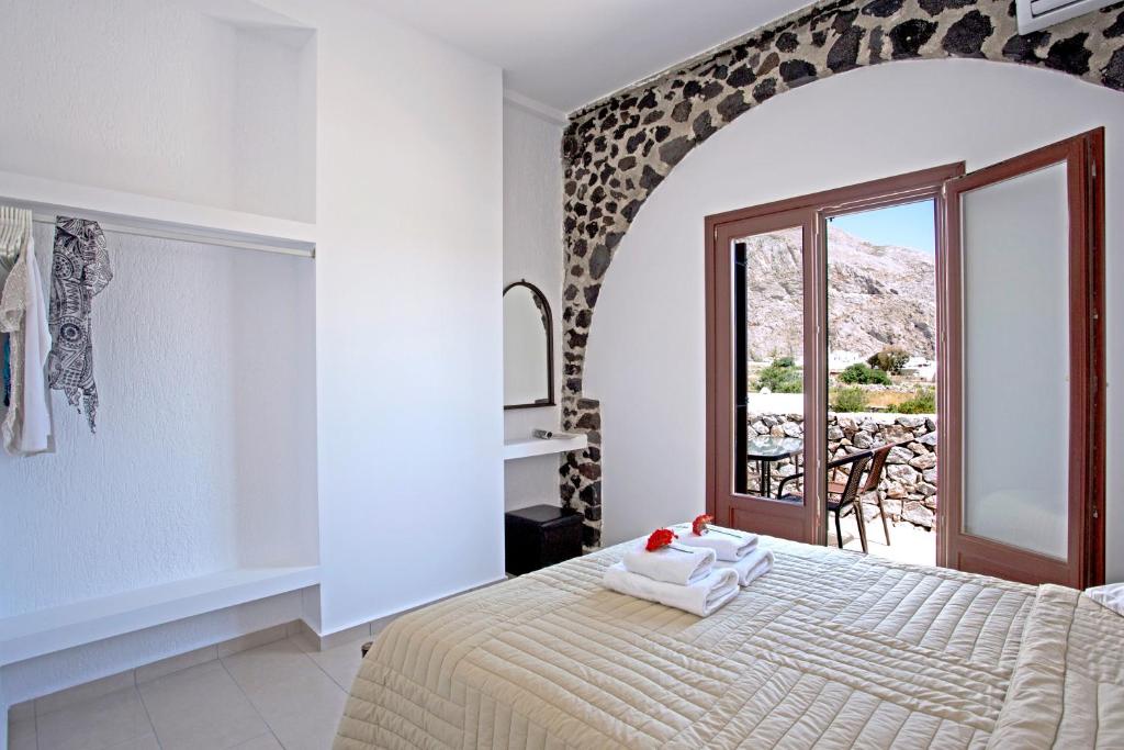 A bed or beds in a room at Birds Villa Apartments - Including Car Rental