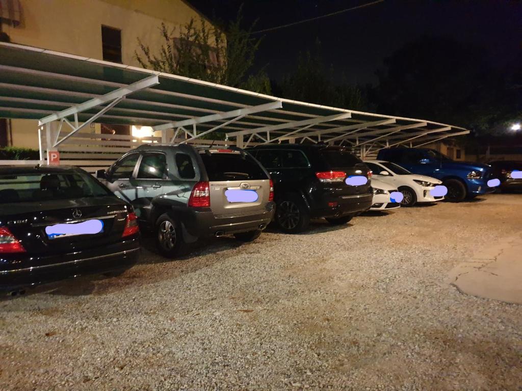 a row of cars parked in a parking lot at Hotel La Favorita in Peschiera del Garda