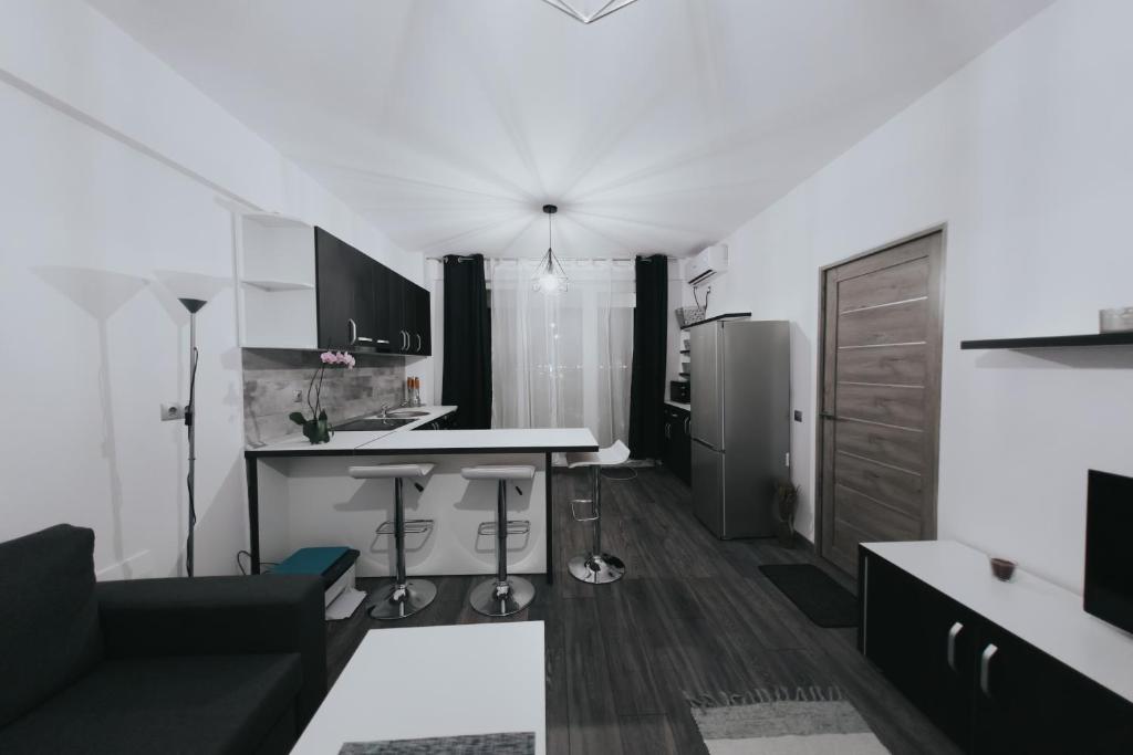 a kitchen with a couch and a table in a room at Urban Apartment in Oradea