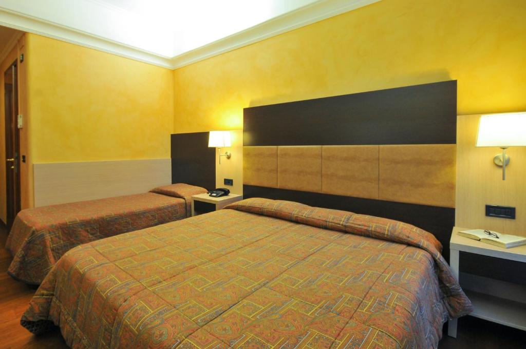 Posteľ alebo postele v izbe v ubytovaní Hotel Enrichetta