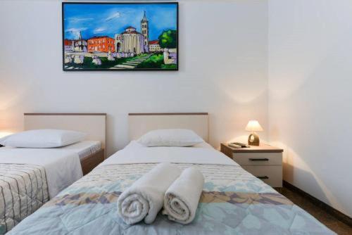 ローマにあるトゥー ダックス ホステルのベッドルーム1室(ベッド2台、タオル付)