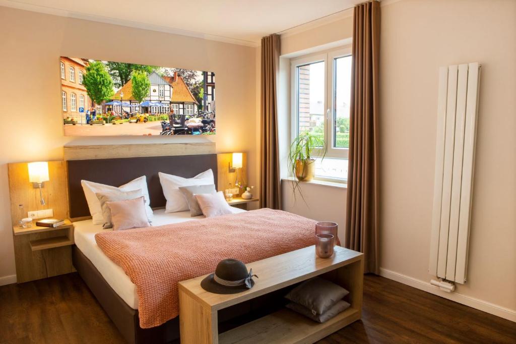 a bedroom with a large bed and a large window at Hotel Velo in Quakenbrück