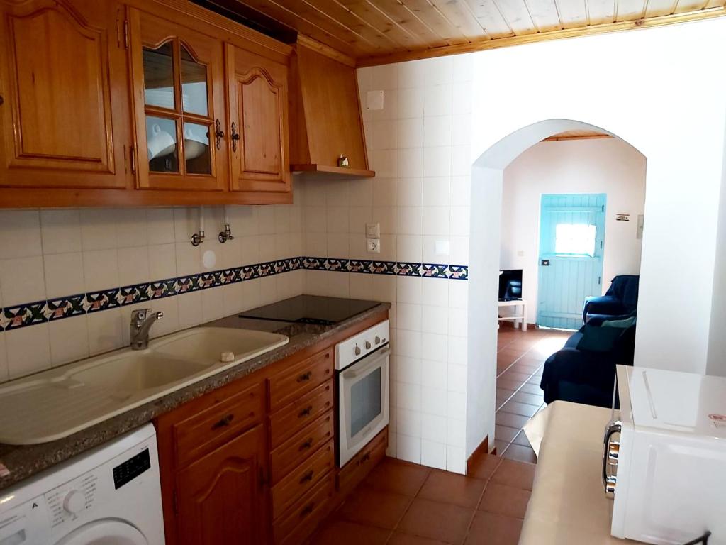 a kitchen with a sink and a dishwasher at The Beach House - Historic Center - Duna Parque Group in Vila Nova de Milfontes