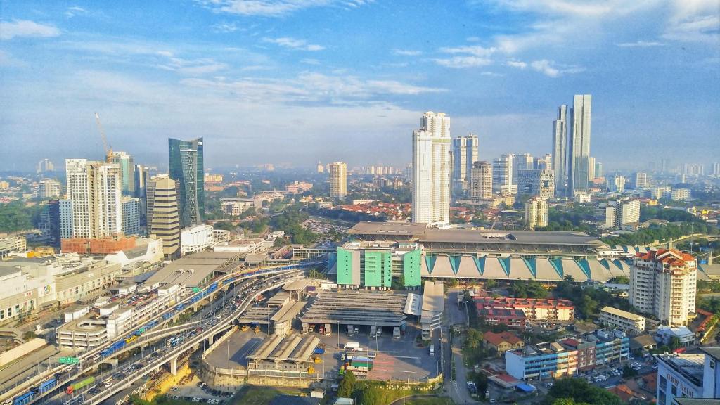 a city with a busy street in front of buildings at R&F Princess Cove by Maco Home in Johor Bahru