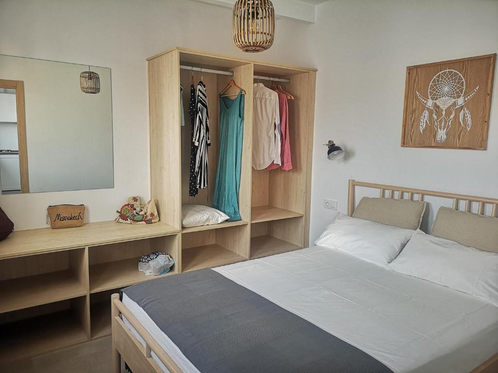 a bedroom with a bed and a vanity and a mirror at LA TRAMONTANA DEL SUR in Tarifa