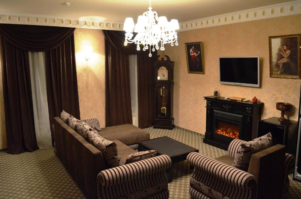a living room with a couch and a fireplace at ANI Mini-hotel in Saint Petersburg