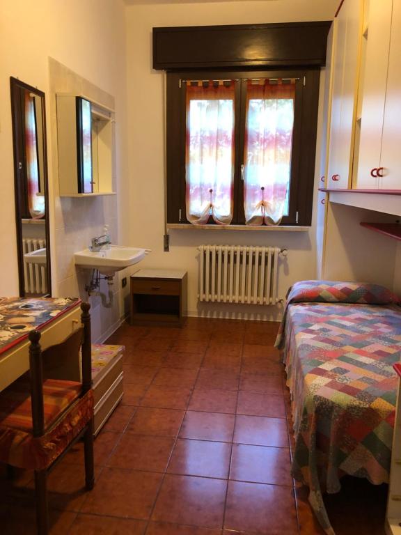 Postel nebo postele na pokoji v ubytování Alloggi Al Giardino & La Suite