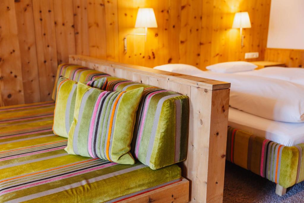 a hotel room with two beds and two beds sidx sidx sidx sidx at Hotel Aurora in Lech am Arlberg