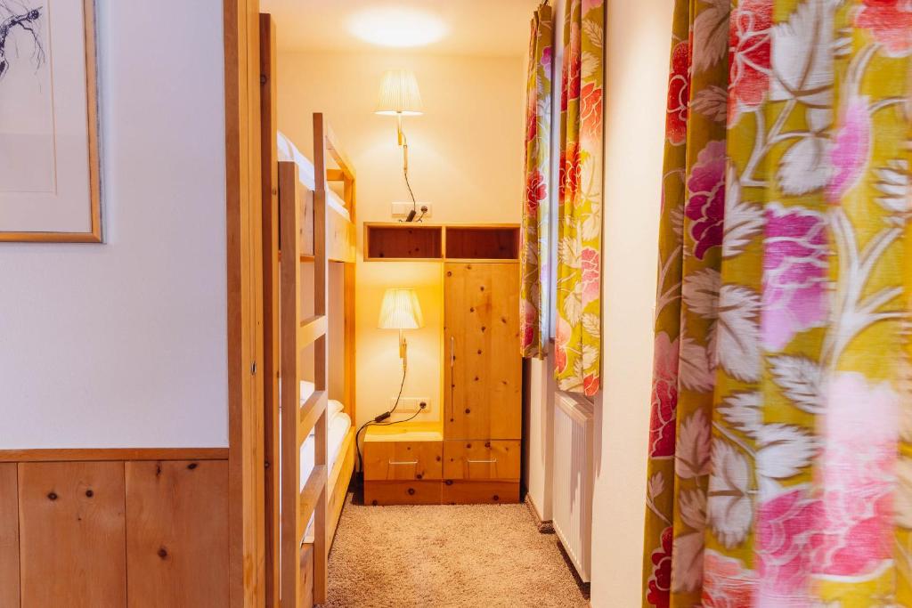a bedroom with a bunk bed and a bunk room with a bunk bed at Hotel Aurora in Lech am Arlberg