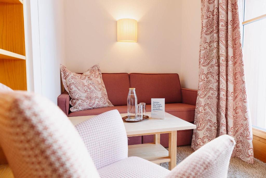 a living room with a couch and a table at Hotel Aurora in Lech am Arlberg