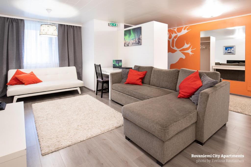 a living room with a couch and a table at Rovaniemi City Apartments in Rovaniemi