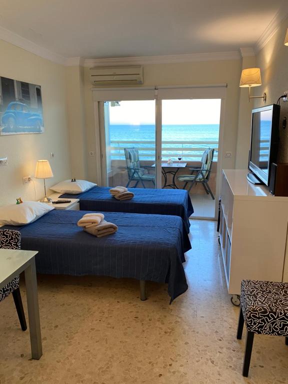 a bedroom with two beds and a view of the ocean at stella maris 1504 in Fuengirola
