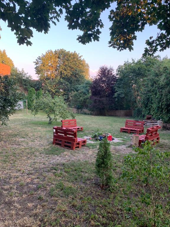 three picnic tables in a field with trees in the background at Villa 25 in Gartz an der Oder