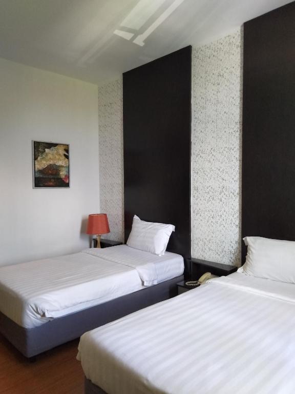 Postel nebo postele na pokoji v ubytování Ginasuite Kompleks27 Hotel