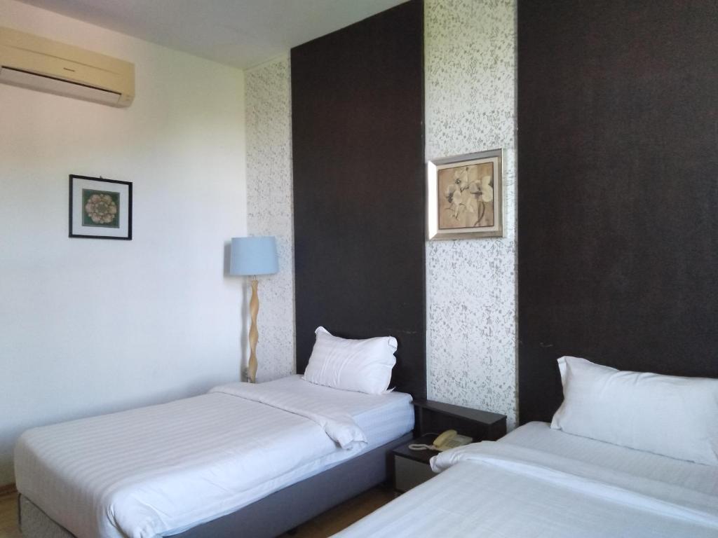 Postel nebo postele na pokoji v ubytování Ginasuite Kompleks27 Hotel