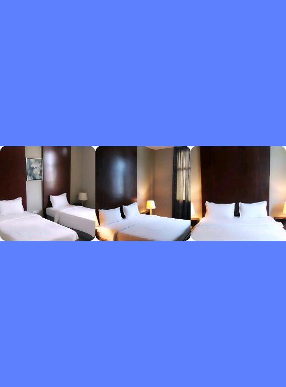 Postel nebo postele na pokoji v ubytování Ginasuite Kompleks27 Hotel