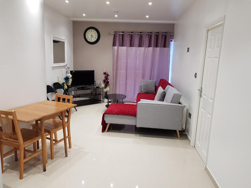 a living room with a couch and a table at Alhambra Suite in Ipswich