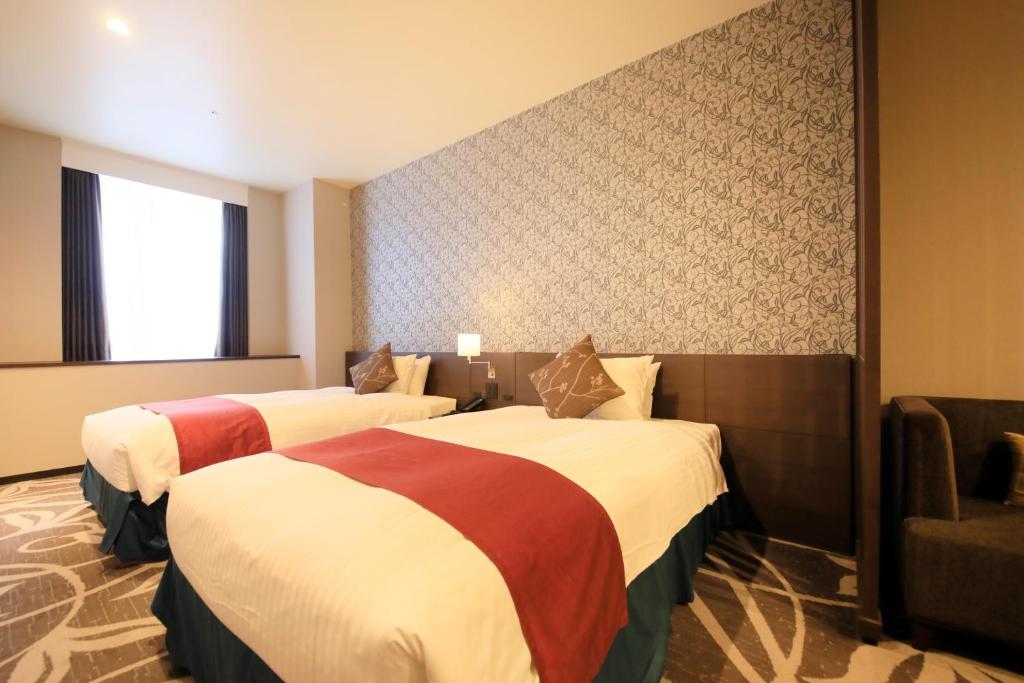 Postel nebo postele na pokoji v ubytování Quintessa Hotel Osaka Bay