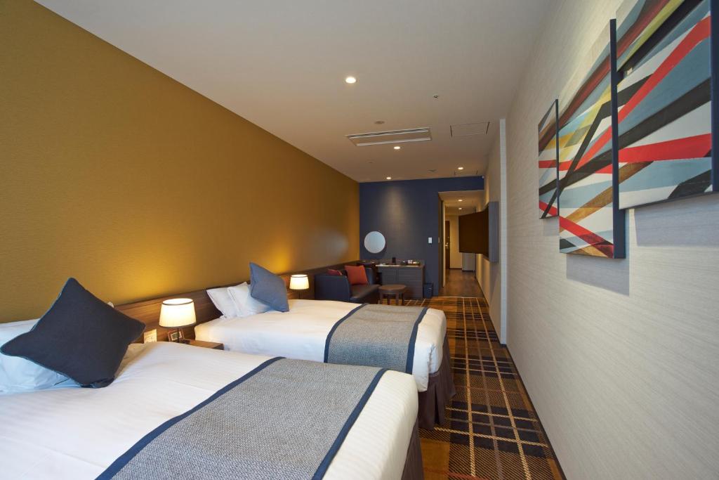 Postel nebo postele na pokoji v ubytování Quintessa Hotel Osaka Bay