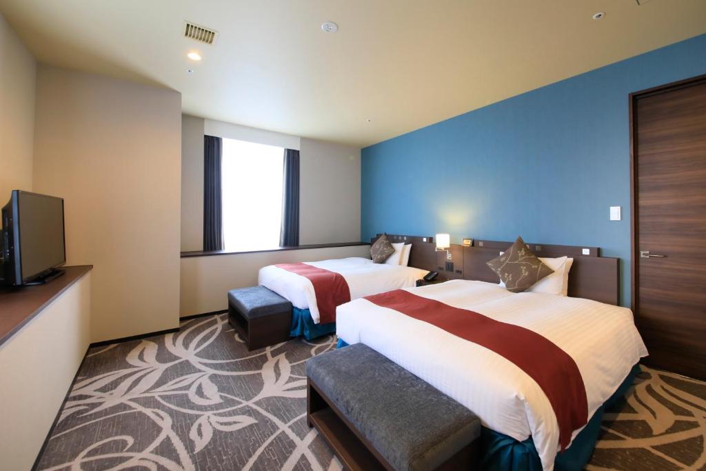 Postel nebo postele na pokoji v ubytování Quintessa Hotel Osaka Bay