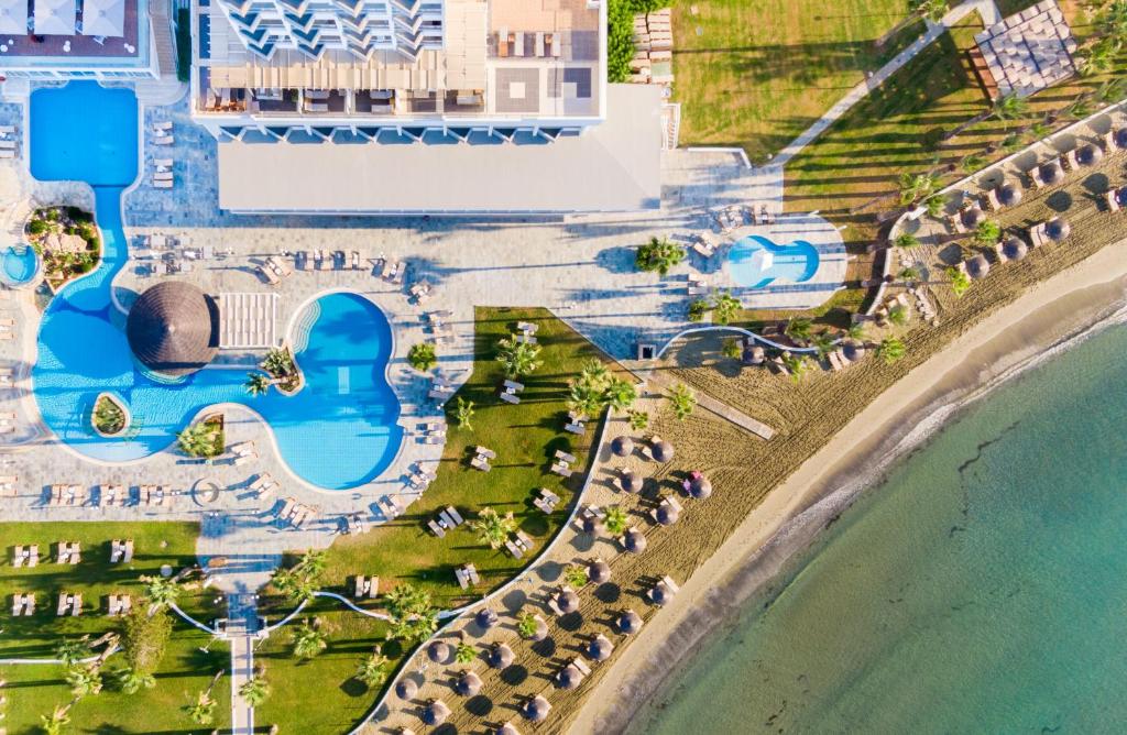 an aerial view of a resort with a pool and beach at Golden Bay Beach Hotel in Larnaka