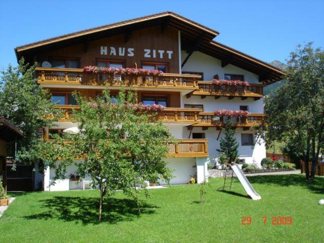 a large building with balconies and flowers on it at Haus Zitt in Grän