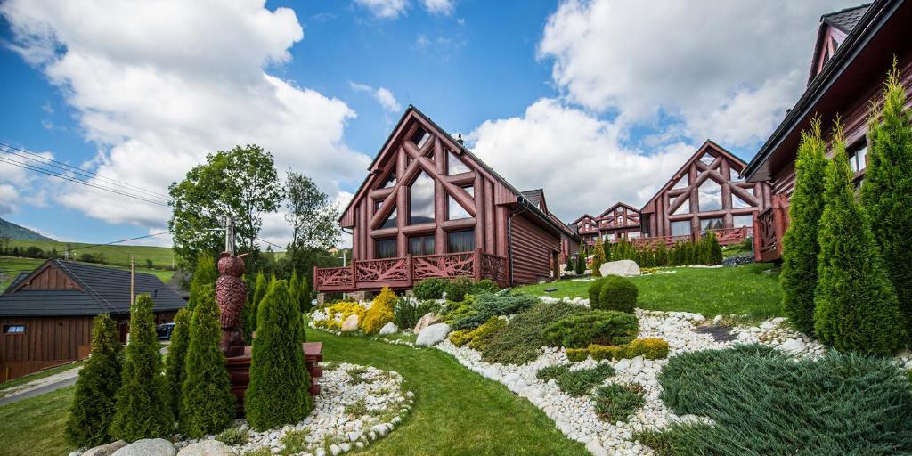 a house with a garden in front of it at Mountain Resort Ždiar - Chalets in Ždiar