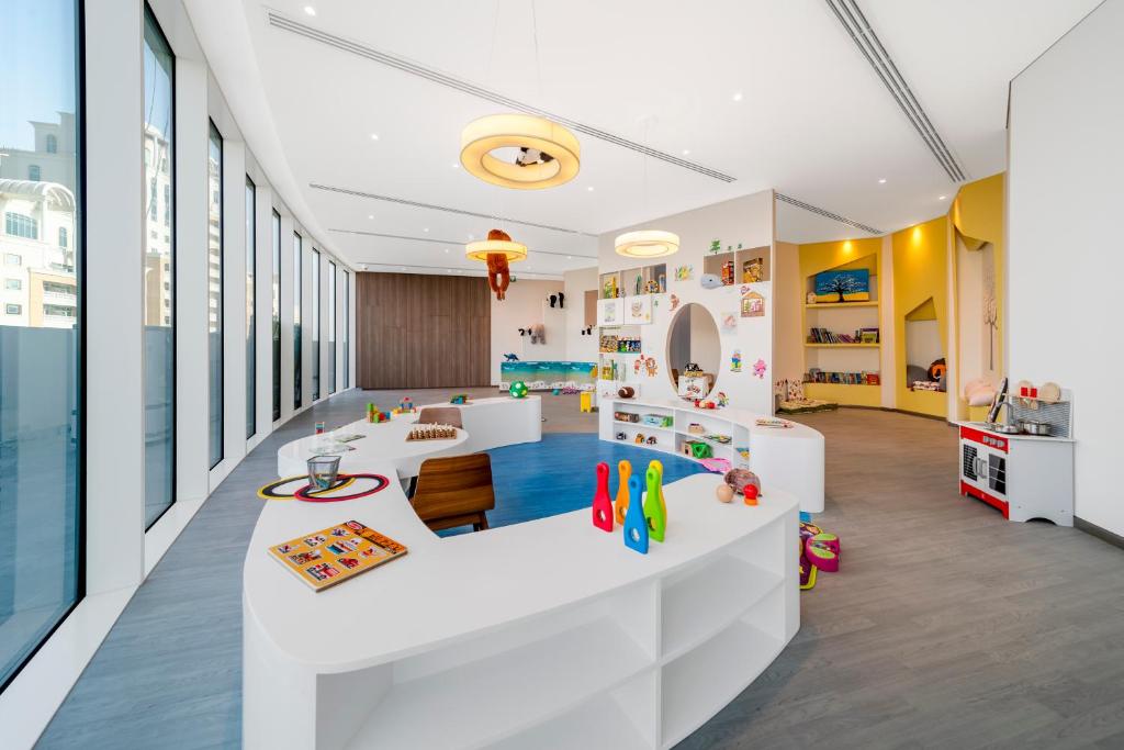 a childrens room with a white table and chairs at FIVE Jumeirah Village in Dubai