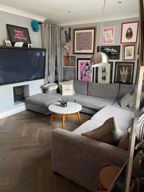 a living room with a couch and a flat screen tv at Luxury 2 bedroom flat heart of Camden in London