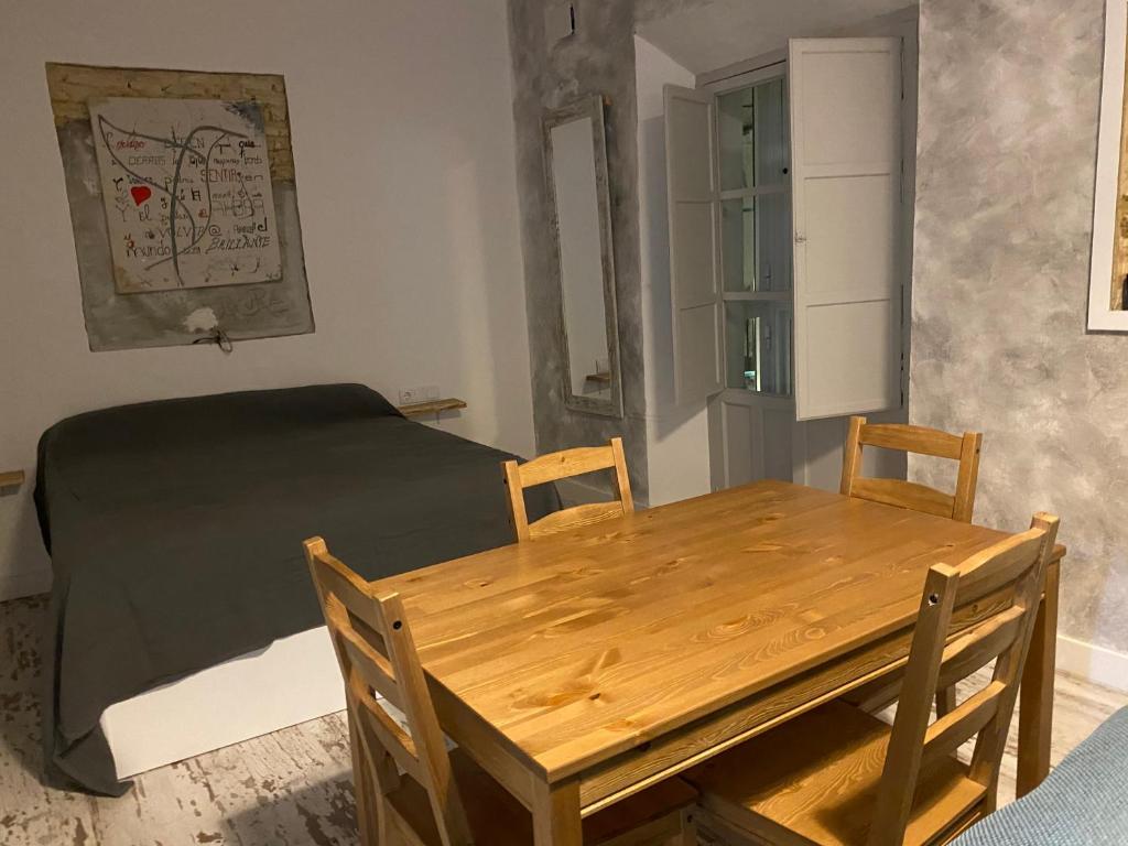 jadalnia ze stołem i łóżkiem w obiekcie LA CUEVA DEL LOCO, Bretones 29 w mieście Sanlúcar de Barrameda