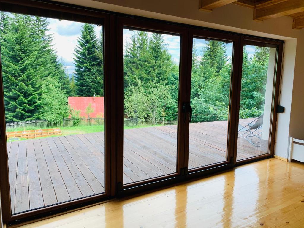 an open sliding glass door with a view of a patio at FlowMove Retreat Kamesznica in Kamesznica