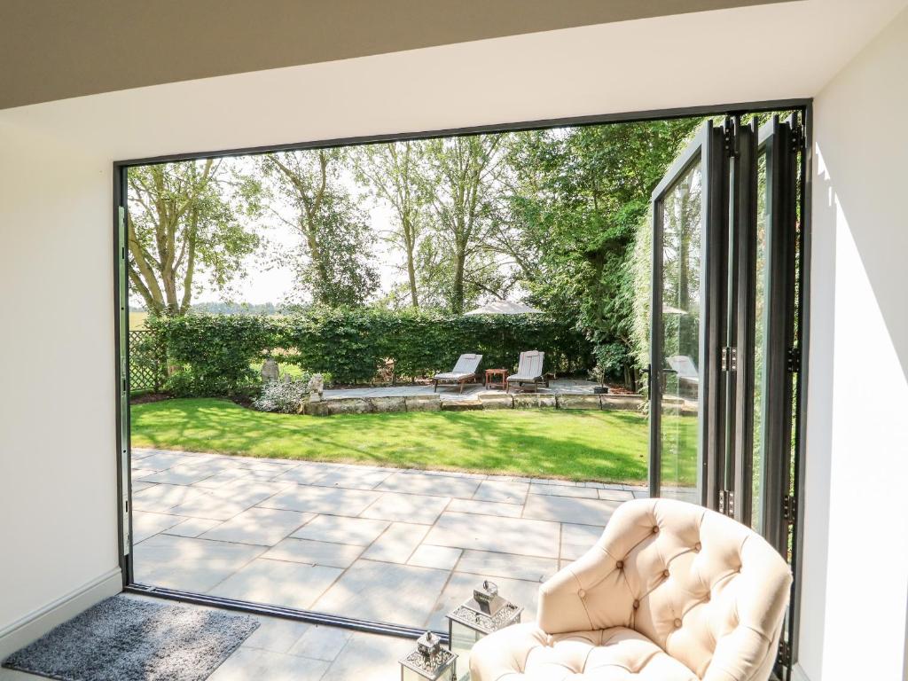 a living room with a large sliding glass door at The Coach House in Sleaford