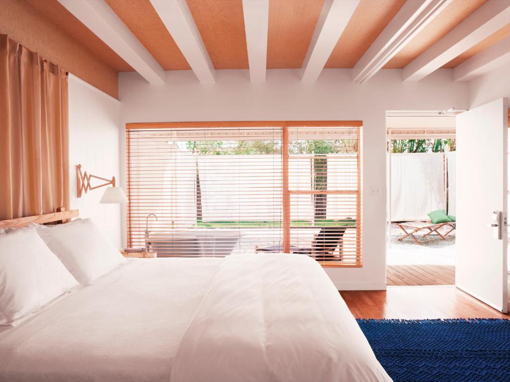 a bedroom with a white bed and a large window at The Standard Miami in Miami Beach