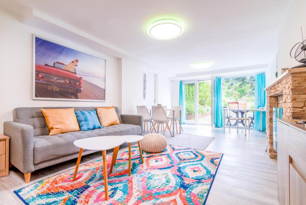 a living room with a couch and a table at Cosy and Colorful apartment Szentendre in Szentendre