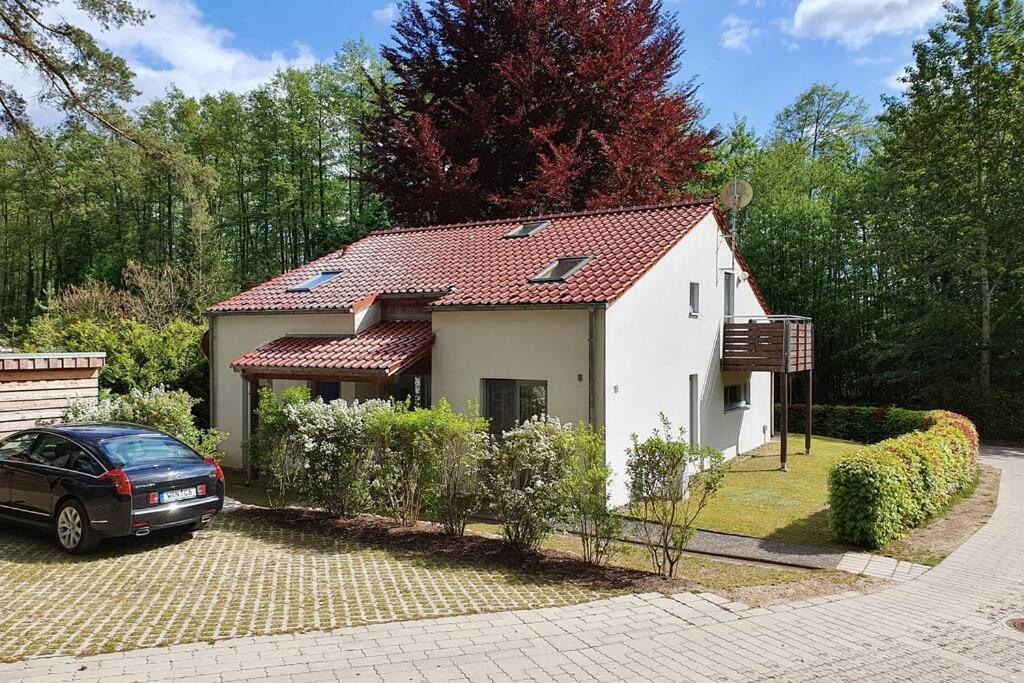 a house with a car parked in front of it at SeeLodge Jabel Appartment 2 in Jabel