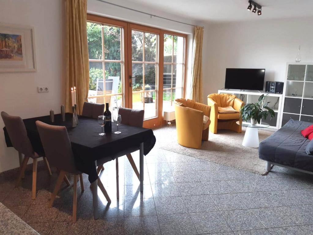 a living room with a black table and chairs at Landhaus Müller in Reith im Alpbachtal