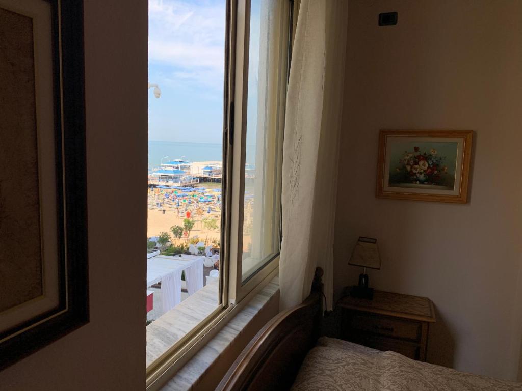 - une chambre avec une fenêtre offrant une vue sur la plage dans l'établissement Beachfront apartment Ridi, à Durrës