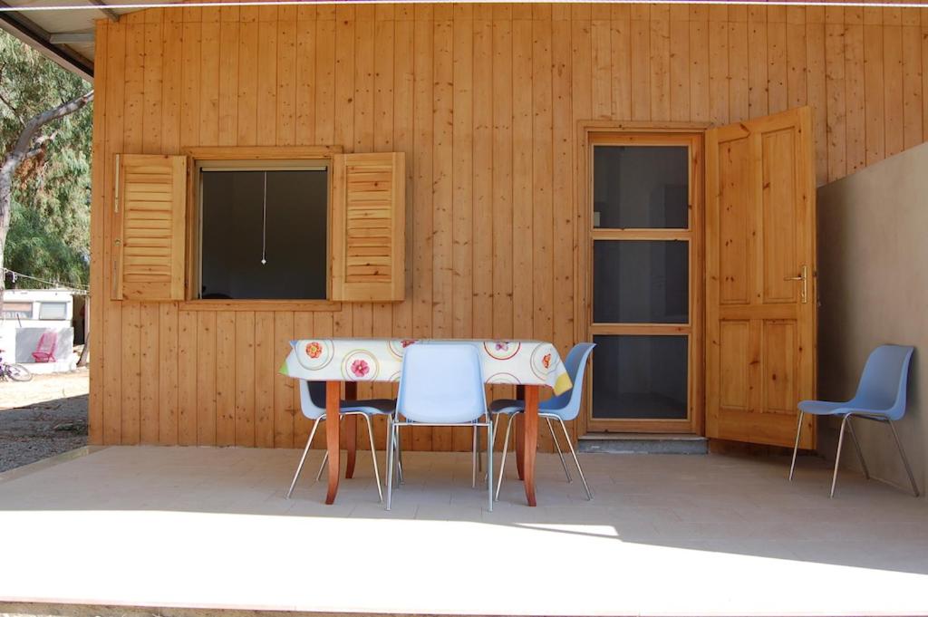 a table and chairs in front of a building at MIMOSA CAMPING in Isca sullo Ionio
