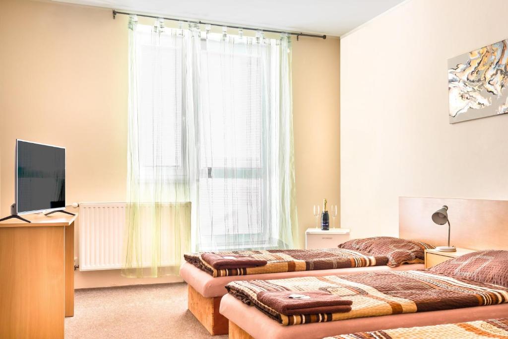 Postel nebo postele na pokoji v ubytování Hotel Zannam