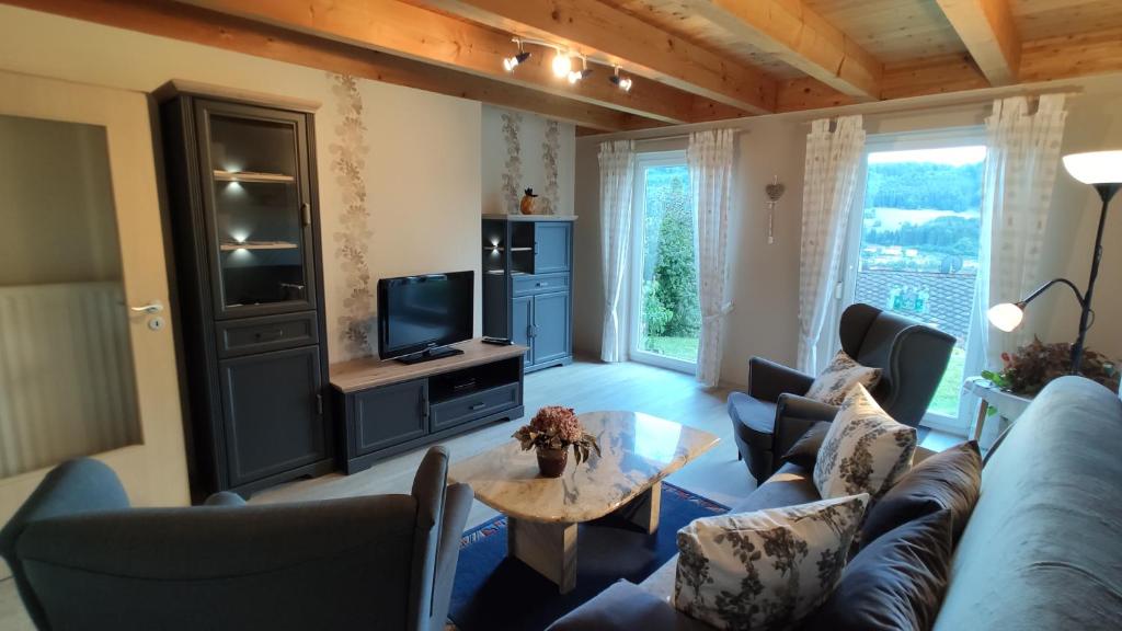 a living room with a couch and a tv at Ferienwohnung Albblick in Albstadt