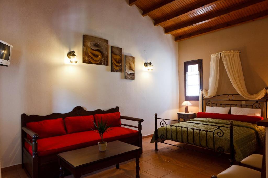 a living room with a bed and a couch at Hovolo Hotel Apartments in Neo Klima